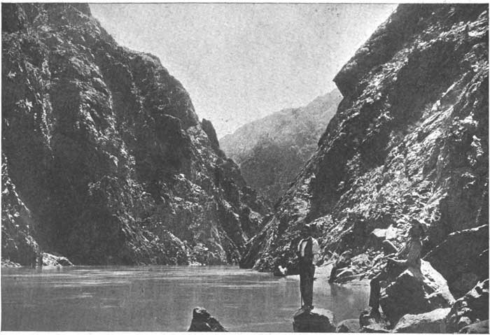1890s photo of tourists standing at the Colorado River within Grand Canyon.