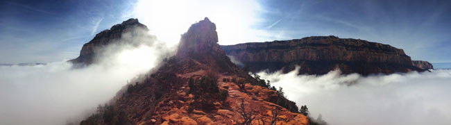 Yaki Point, Cedar Ridge, and Yavapai Point stand above a layer of clouds.